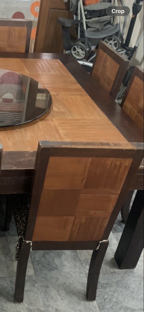 Large Wooden Dining Table with 8 Leopard Print Chairs (Category: Tables & Sets) located in Manila. Submitted by samsongarcia (Listing ID 1466889433, Image 3). Description: Big square wooden dining table with a dark brown outer frame, parquet top pattern, and a revolving black lazy Susan glass tray in the middle. Includes eight matching dining chairs with checkerboard wooden backs and leopard print fabric seats. Sturdy setup, seats a large family 