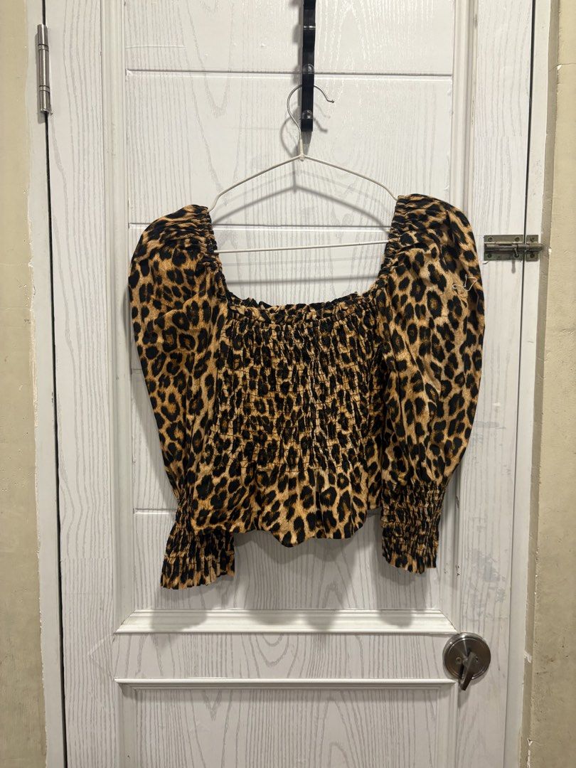 Leopard Print Square Neck Smocked Long Sleeve Blouse (Category: Longsleeves) located in Mandaluyong City. Submitted by shopwithjuu (Listing ID 1466810909, Image 1). Description: Chic leopard print top featuring a flattering square neckline, smocked bodice, and trendy puffy sleeves with ruffled cuffs. Perfect for pairing with high-waisted jeans or skirts for a stylish look..