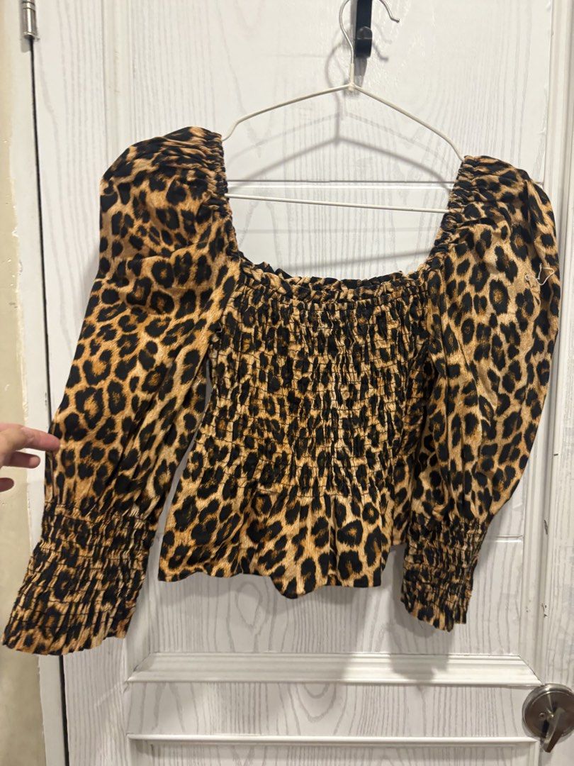 Leopard Print Square Neck Smocked Long Sleeve Blouse (Category: Longsleeves) located in Mandaluyong City. Submitted by shopwithjuu (Listing ID 1466810909, Image 2). Description: Chic leopard print top featuring a flattering square neckline, smocked bodice, and trendy puffy sleeves with ruffled cuffs. Perfect for pairing with high-waisted jeans or skirts for a stylish look..