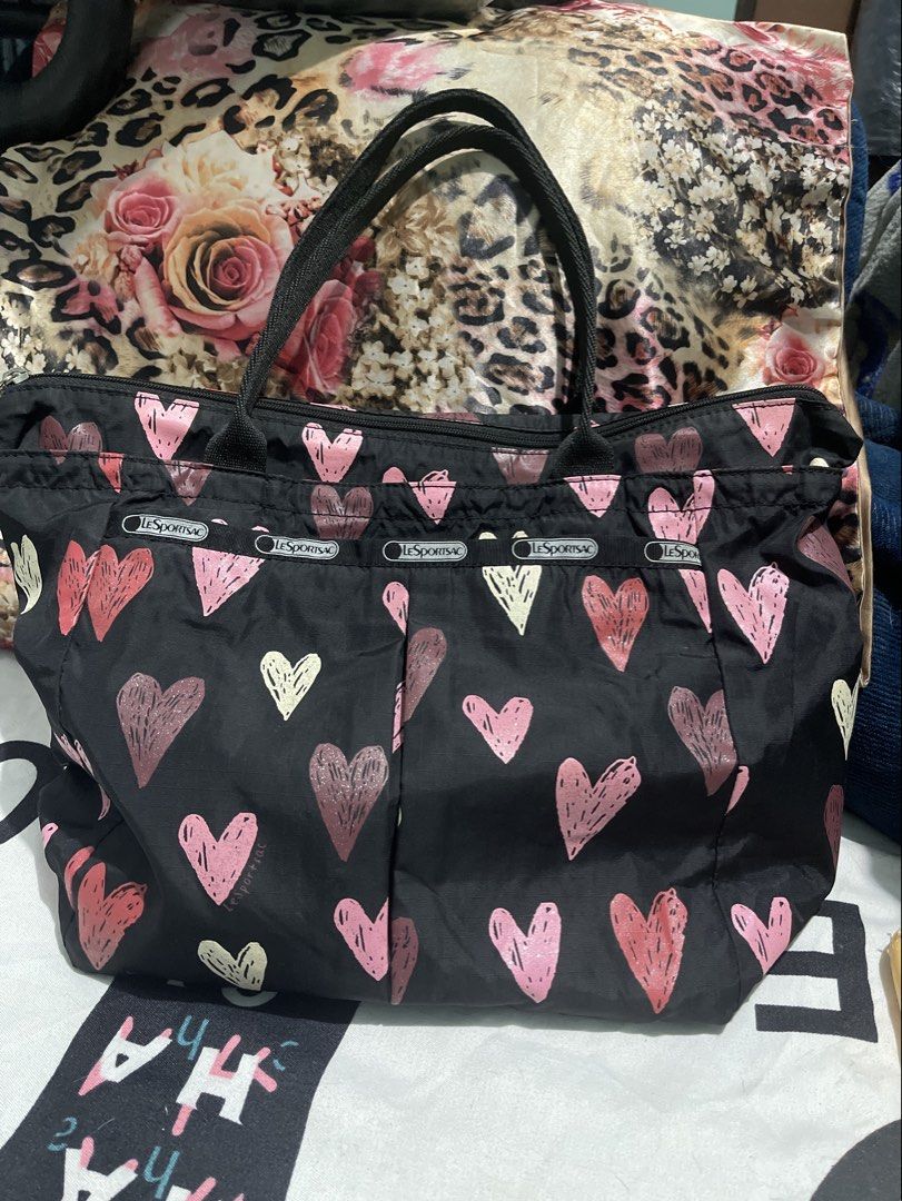 LeSportsac Black Heart Pattern Tote Bag (Category: Tote Bags) located in Manila. Submitted by edensy (Listing ID 1465079280, Image 1). Description: - Brand: LeSportsac - Design: Playful all-over heart print with branded ribbon trim - Colors: Classic black exterior with a vibrant red interior lining - Closure: Secure top zip closure - Handles: Comfortable dual carrying handles - Storage: Roomy main compartment fits all your daily essentials - Mode