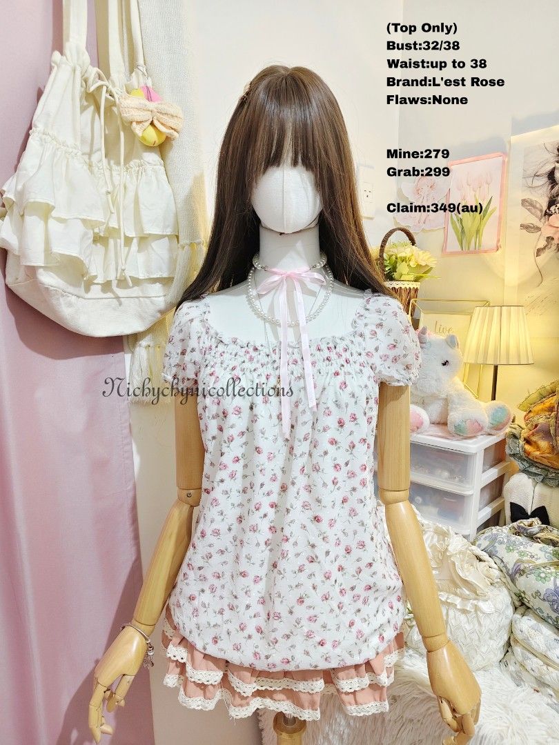 L'est Rose Floral Off-Shoulder Top (Category: Blouses) located in Manila. Submitted by chynii_28 (Listing ID 1466867370, Image 1). Description: - Brand: L'est Rose - Design: White floral blouse with small pink roses and subtle dot texture - Details: Square neckline, short puff sleeves, and comfortable smocked elastic chest - Fit: Flowy drape, fits bust 32 to 38 inches and waist up to 38 inches - Condition: 10/10, zero flaws found.