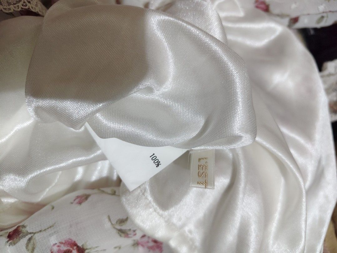 L'est Rose Floral Off-Shoulder Top (Category: Blouses) located in Manila. Submitted by chynii_28 (Listing ID 1466867370, Image 2). Description: - Brand: L'est Rose - Design: White floral blouse with small pink roses and subtle dot texture - Details: Square neckline, short puff sleeves, and comfortable smocked elastic chest - Fit: Flowy drape, fits bust 32 to 38 inches and waist up to 38 inches - Condition: 10/10, zero flaws found.