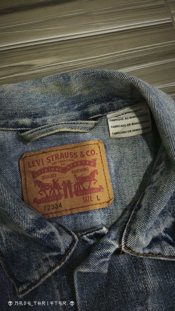 Levi's 72334 Denim Trucker Jacket Size L (Category: Coats, Jackets and Outerwear) located in Lingayen. Submitted by c7quiter84444 (Listing ID 1466932362, Image 2). Description: - Brand: Levi's - Style: Denim Trucker Jacket (Style #72334) - Wash: Light wash with yellow contrast stitching - Size: Large (Relaxed fit) - Material: 100% Cotton - Features: Metal button-front closure, two chest flap pockets, two side welt pockets, iconic red tab, and int