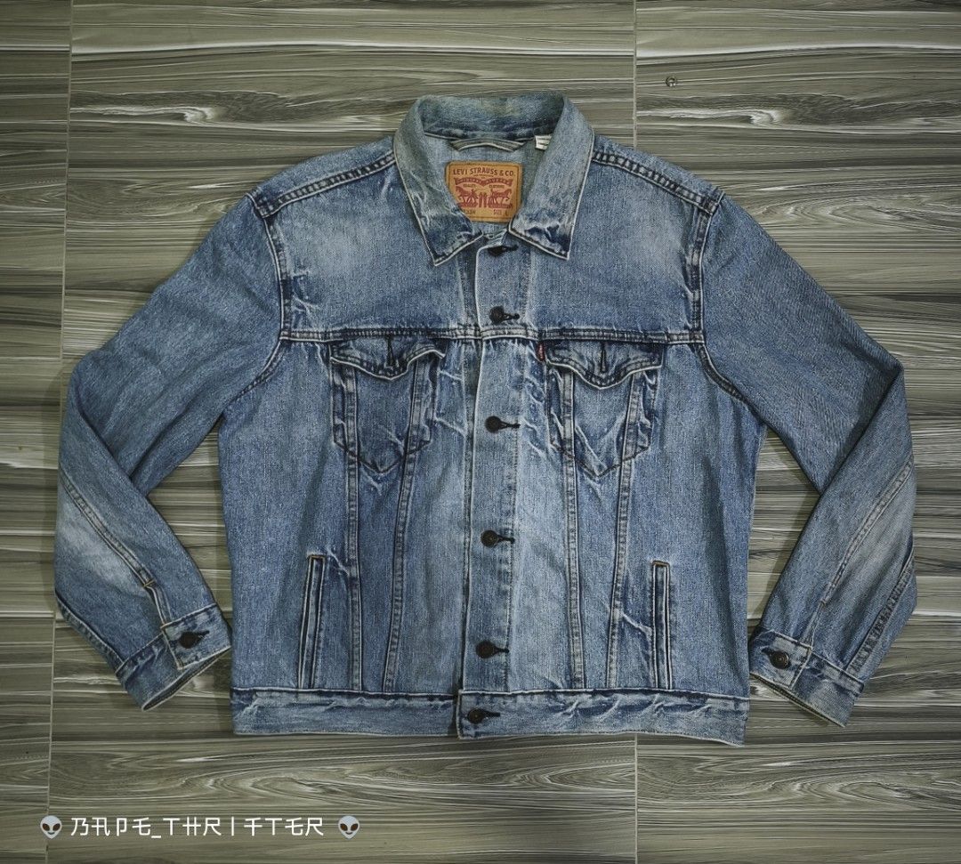 Levi's 72334 Denim Trucker Jacket Size L (Category: Coats, Jackets and Outerwear) located in Lingayen. Submitted by c7quiter84444 (Listing ID 1466932362, Image 1). Description: - Brand: Levi's - Style: Denim Trucker Jacket (Style #72334) - Wash: Light wash with yellow contrast stitching - Size: Large (Relaxed fit) - Material: 100% Cotton - Features: Metal button-front closure, two chest flap pockets, two side welt pockets, iconic red tab, and int