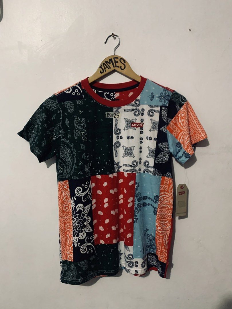 Levi's Bandana Patchwork T-Shirt Multi Color (Category: Shirts) located in Manila. Submitted by tanjames.14 (Listing ID 1466891379, Image 1). Description: - Brand: Levi's - Condition: Brand new with tags (BNWT) - Design: Colorful all-over bandana patchwork print with a red ribbed collar - Details: Small embroidered Levi's logo patch on the chest - Measurements: 18" pit-to-pit, 25" length - Perfect for adding a unique, streetwear touch to your out