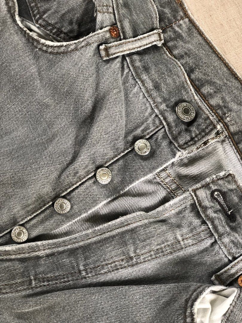 Levi's Grey Vintage Button-Fly Denim Jeans (Category: Jeans) located in Tarlac. Submitted by jds_thrift (Listing ID 1466835286, Image 3). Description: Vintage grey Levi's denim jeans with button-fly closure and classic back pocket stitching. Faded wash throughout with heavy distressing and visible professional reinforcement repairs at the crotch seam. Original leather patch intact on the back waistband. Heavy wear adds authentic character and bro