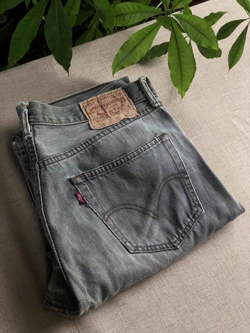 Levi's Grey Vintage Button-Fly Denim Jeans (Category: Jeans) located in Tarlac. Submitted by jds_thrift (Listing ID 1466835286, Image 1). Description: Vintage grey Levi's denim jeans with button-fly closure and classic back pocket stitching. Faded wash throughout with heavy distressing and visible professional reinforcement repairs at the crotch seam. Original leather patch intact on the back waistband. Heavy wear adds authentic character and bro