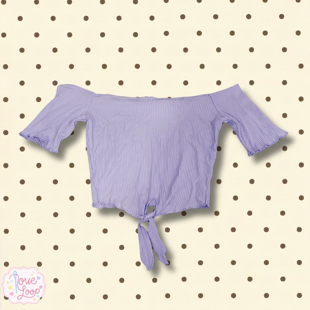 Lilac Off-Shoulder Ribbed Crop Top With Front Tie (Category: Sleeveless) located in Manila. Submitted by love.loop (Listing ID 1466891587, Image 1). Description: - Color: Lilac - Style: Off-shoulder crop top with short flared sleeves - Details: Front tie knot at bottom hem - Fabric: Stretchy, all-over ribbed texture - Fit: Easy to pair with high-waisted denim or skirts - Condition: Brand new.