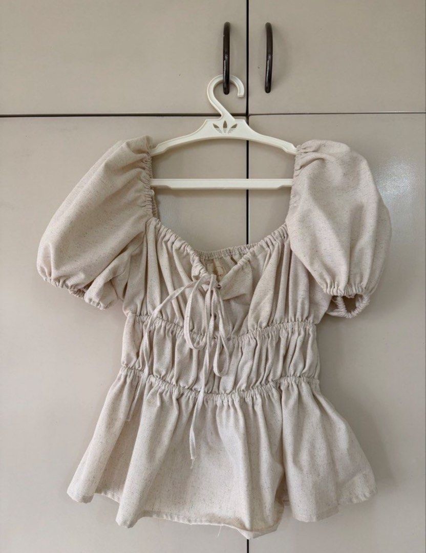 Linen Puff Sleeve Peplum Top (Category: Blouses) located in Pasig City. Submitted by deedee235 (Listing ID 1466826503, Image 2). Description: - Style: Premium Muối Tiêu top with square neckline and puff sleeves - Material: High-quality linen tưng fabric (twice as thick as regular linen, soft, and breathable) - Fit & Details: Smocked waist body for a flattering fit and front tie ribbon accent - Durability: Highly durable and long-lasting fabric - 