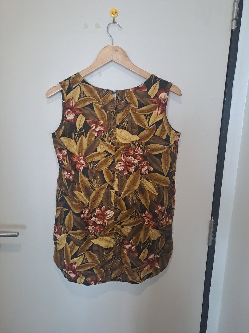 Linen tropical sleeveless (Category: Others Tops) located in Manila. Submitted by joanbalde39643 (Listing ID 1466839376, Image 2). Description: This is a sleeveless tropical blouse featuring an all-over botanical print with lush autumn-toned leaves, palms, and hibiscus flowers in shades of olive green, warm brown, tan, and dark burgundy. Designed with a classic round neckline and a fluid, comfortable drape, this type of shift top or tunic is perf