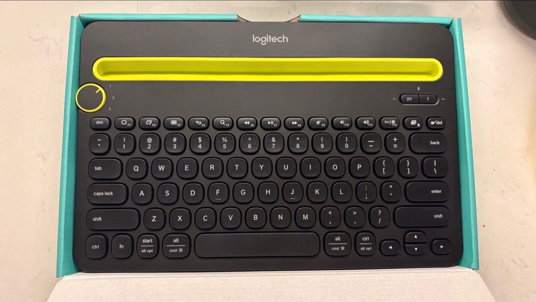 Logitech K480 Multi-Device Bluetooth Keyboard (Category: Computer Keyboard) located in Singapore. Submitted by ticktockdrip (Listing ID 1466879708, Image 2). Description: - Model: Logitech K480 Multi-Device Bluetooth Keyboard - Color: Black body with vibrant yellow cradle and dial accents - Compatibility: Works seamlessly with Windows, Mac, Chrome OS, Android, and iOS - Multi-Device: Easy-switch dial lets you connect and toggle between 3 devices 