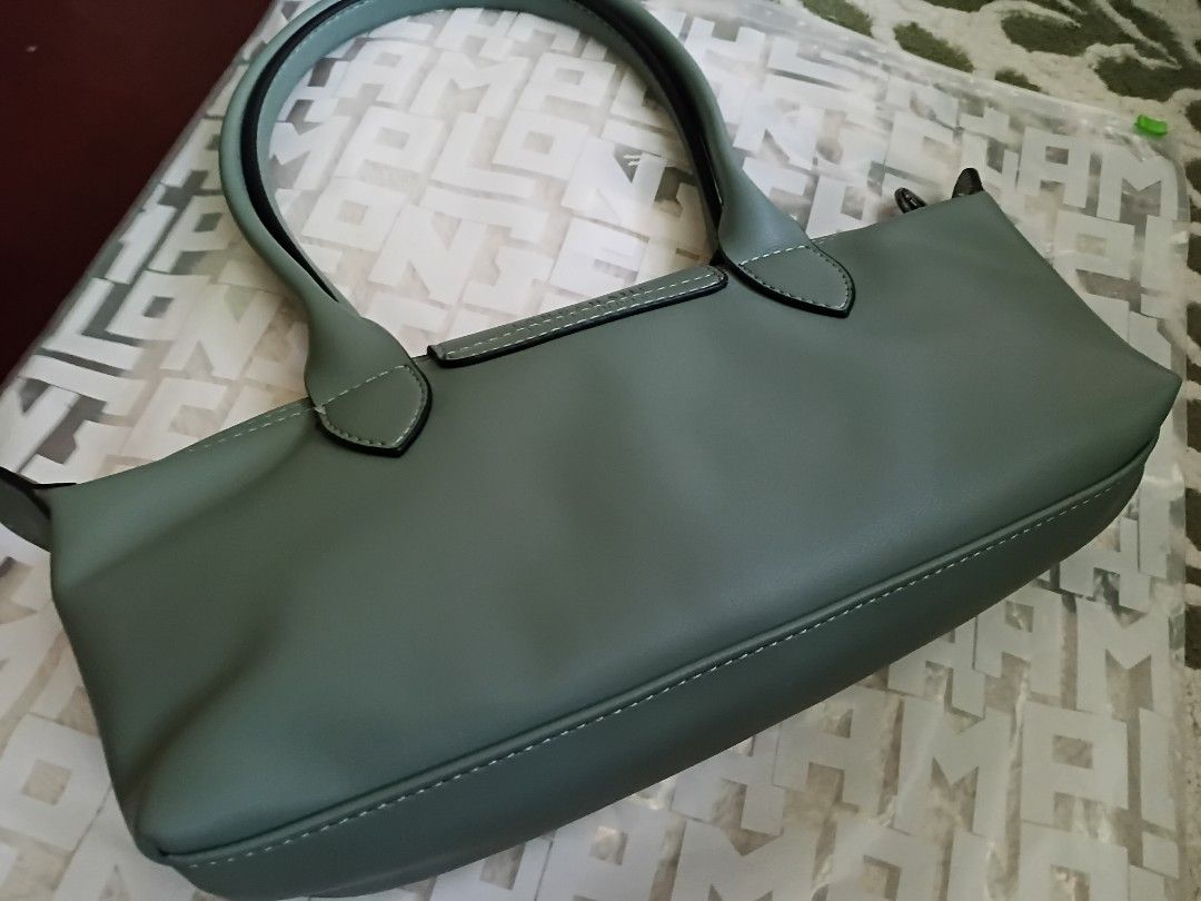 REPRICED!✅️Longchamp Le Pliage Extra Siphon Sage Green (Category: Luxury Bags & Wallets) located in Muntinlupa City. Submitted by apobangpo_ot7 (Listing ID 1466803148, Image 3). Description: Bought it from 🇰🇷 Outlet Store - Brand: Longchamp Le Pliage Extra Siphon - Color: • Tundra (sage green) • Material: Smooth cowhide leather - Style: Tubular shoulder bag with snap button flap and zipper closure - Details: Contrast stitching and embossed logo
