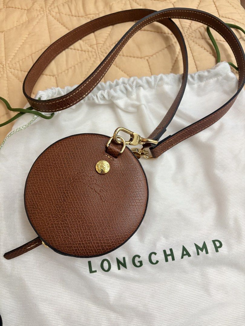 Longchamp Round mini expandable (Category: Cross-body Bags) located in Manila. Submitted by budgetpreloveditems (Listing ID 1466881259, Image 2). Description: - Authentic Longchamp round crossbody bag in classic brown leather - Elegant gold-tone hardware with secure zip closure - Long, adjustable strap attached with convenient lobster clasps - Features clean, premium stitching throughout - Includes matching white Longchamp dust bag - Comes with a