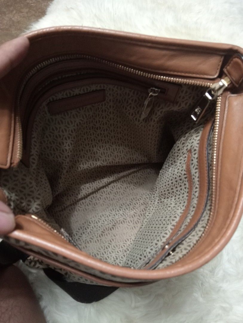 Louis Quatorze Monogram Crossbody Bag (Category: Cross-body Bags) located in Cabadbaran. Submitted by lioness_cave (Listing ID 1466957285, Image 3). Description: - Brand: Louis Quatorze Crossbody Bag - Design: All-over monogram pattern with stylish tan leather trim - Strap: Adjustable dark brown shoulder strap for customized comfort - Closure: Secure zipper top closure - Interior: Monogram-printed lining with a convenient zip pocket and leather b