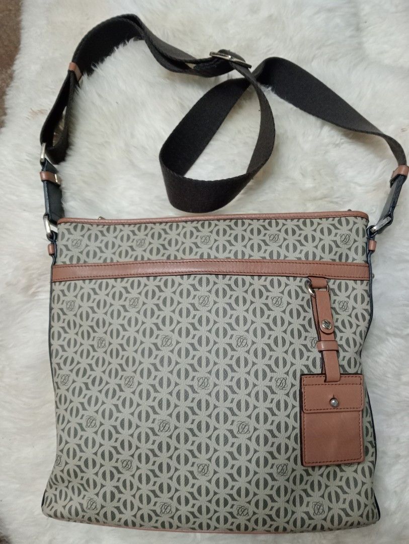Louis Quatorze Monogram Crossbody Bag (Category: Cross-body Bags) located in Cabadbaran. Submitted by lioness_cave (Listing ID 1466957285, Image 1). Description: - Brand: Louis Quatorze Crossbody Bag - Design: All-over monogram pattern with stylish tan leather trim - Strap: Adjustable dark brown shoulder strap for customized comfort - Closure: Secure zipper top closure - Interior: Monogram-printed lining with a convenient zip pocket and leather b