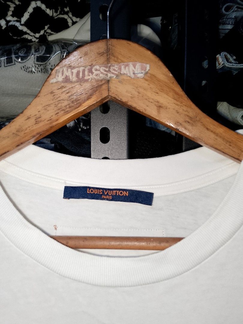 Louis Vuitton Cable Pattern T-shirt White Size L (Category: Tshirts & Polo Shirts ) located in Manila. Submitted by mjthrifted_second (Listing ID 1466840641, Image 3). Description: Louis Vuitton white t-shirt, cable pattern text printed on the front. Hands knitting graphic printed on the back with an orange leather brand tag near the collar. Made in Italy, size L. Clean fabric, collar tags intact. Size Large Dimes 22/29.