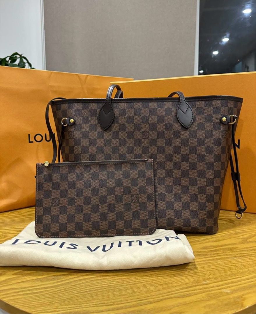 Louis Vuitton Damier Ebene Neverfull Tote Bag (Category: Luxury Bags & Wallets) located in Davao. Submitted by sharpeeeee_ (Listing ID 1466779884, Image 1). Description: - Authentic Louis Vuitton Damier Ebene canvas tote bag - Classic brown checkered pattern with dark brown leather straps - Includes matching detachable pouch - Comes with original dust bag and large orange LV shopping bag - Clean interior and well-maintained exterior - Spacious an