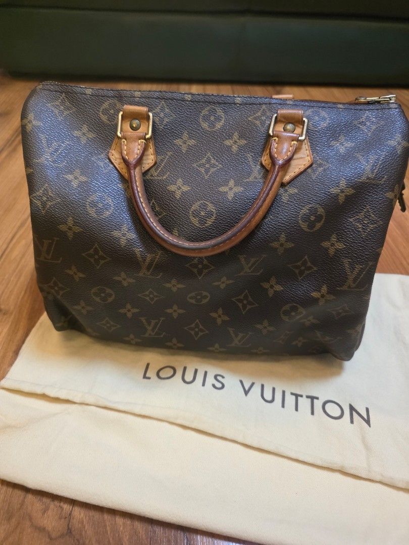 Louis Vuitton Monogram Canvas Handbag with Dust Bag (Category: Luxury Bags & Wallets) located in Iligan City. Submitted by ilovechocolatecakes (Listing ID 1466784197, Image 1). Description: - Authentic Classic Louis Vuitton monogram canvas handbag - Secure zipper closure with comfortable dual leather handles - Brown fabric-lined interior featuring convenient slip pocket compartments - Includes original cream-colored Louis Vuitton logo dust bag - 