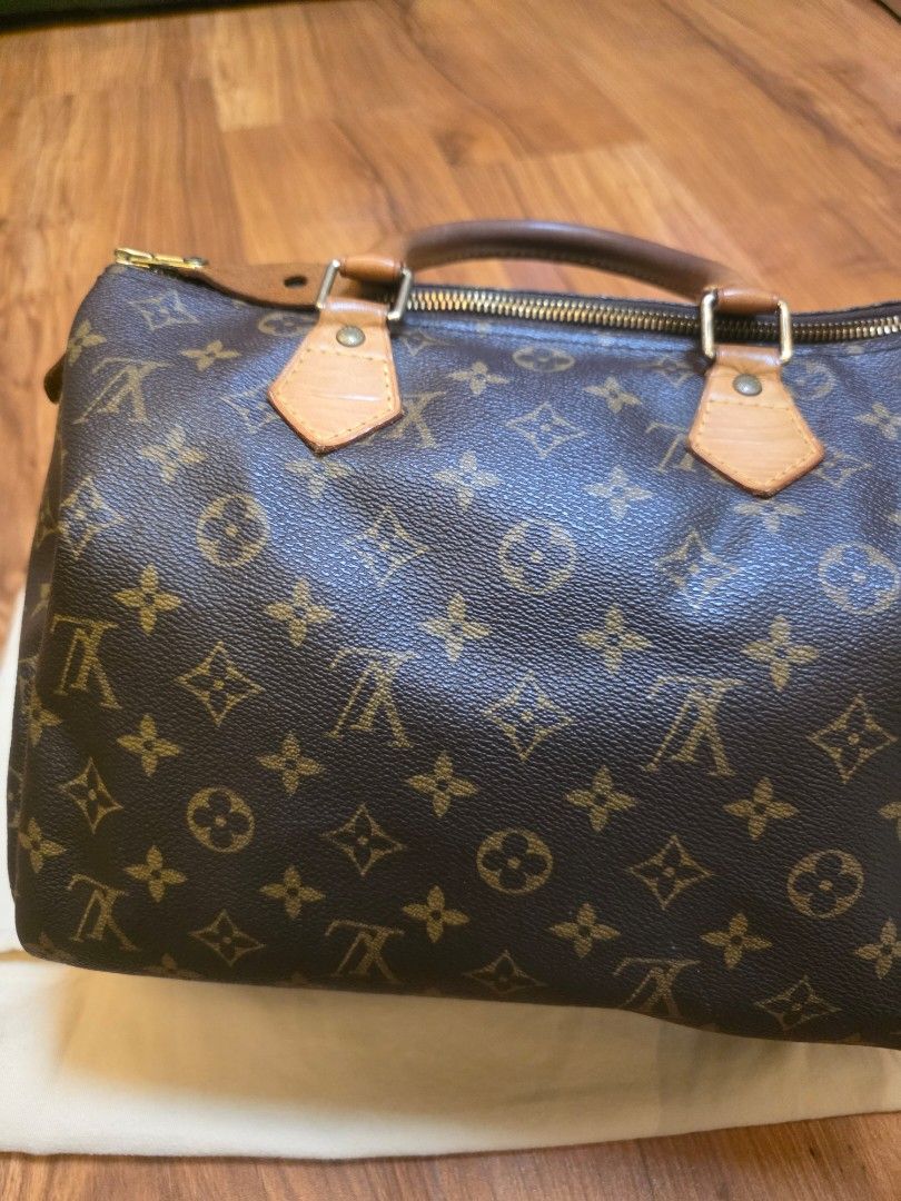 Louis Vuitton Monogram Canvas Handbag with Dust Bag (Category: Luxury Bags & Wallets) located in Iligan City. Submitted by ilovechocolatecakes (Listing ID 1466784197, Image 2). Description: - Authentic Classic Louis Vuitton monogram canvas handbag - Secure zipper closure with comfortable dual leather handles - Brown fabric-lined interior featuring convenient slip pocket compartments - Includes original cream-colored Louis Vuitton logo dust bag - 