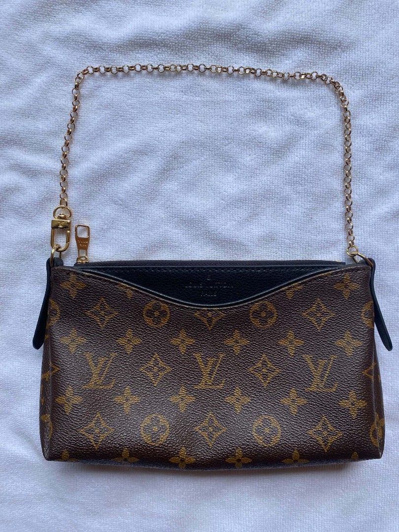 Louis Vuitton Monogram Canvas Multi Pochette Accessoires Pouch (Category: Luxury Bags & Wallets) located in Maco. Submitted by seidcaeeverydayfinds888 (Listing ID 1466909007, Image 1). Description: - Authentic Louis Vuitton monogram canvas pouch in classic brown and tan - Stylish black leather trim along the top opening and side tabs - Gleaming gold-tone hardware and secure zipper closure - Includes a removable gold chain strap with a convenient 