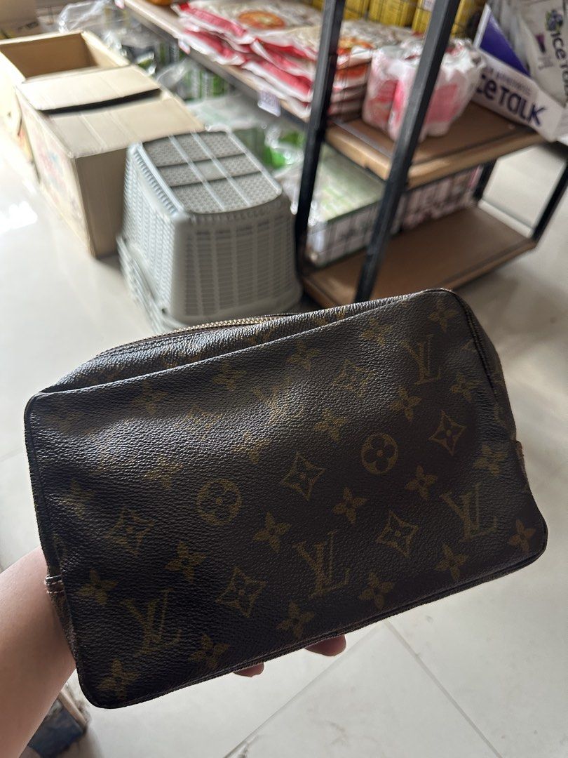 Louis Vuitton Monogram Cosmetic Pouch (Category: Luxury Bags & Wallets) located in Bustos. Submitted by theprelovedshopbulacan (Listing ID 1466835145, Image 1). Description: - Classic brown monogram canvas exterior in clean condition - Secure zip-top closure with metal pull - Spacious interior featuring elasticated side pockets - Light-colored interior lining has visible ink marks and stains from past use - Perfect size for organizing daily makeu