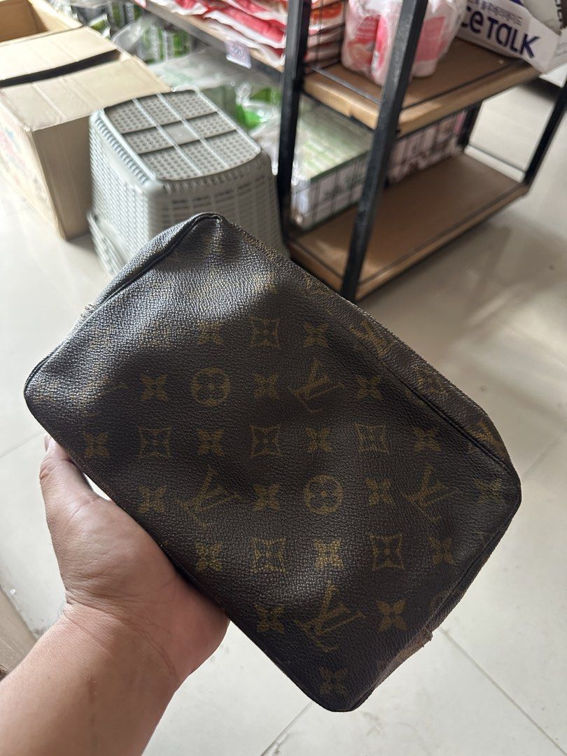 Louis Vuitton Monogram Cosmetic Pouch (Category: Luxury Bags & Wallets) located in Bustos. Submitted by theprelovedshopbulacan (Listing ID 1466835145, Image 2). Description: - Classic brown monogram canvas exterior in clean condition - Secure zip-top closure with metal pull - Spacious interior featuring elasticated side pockets - Light-colored interior lining has visible ink marks and stains from past use - Perfect size for organizing daily makeu