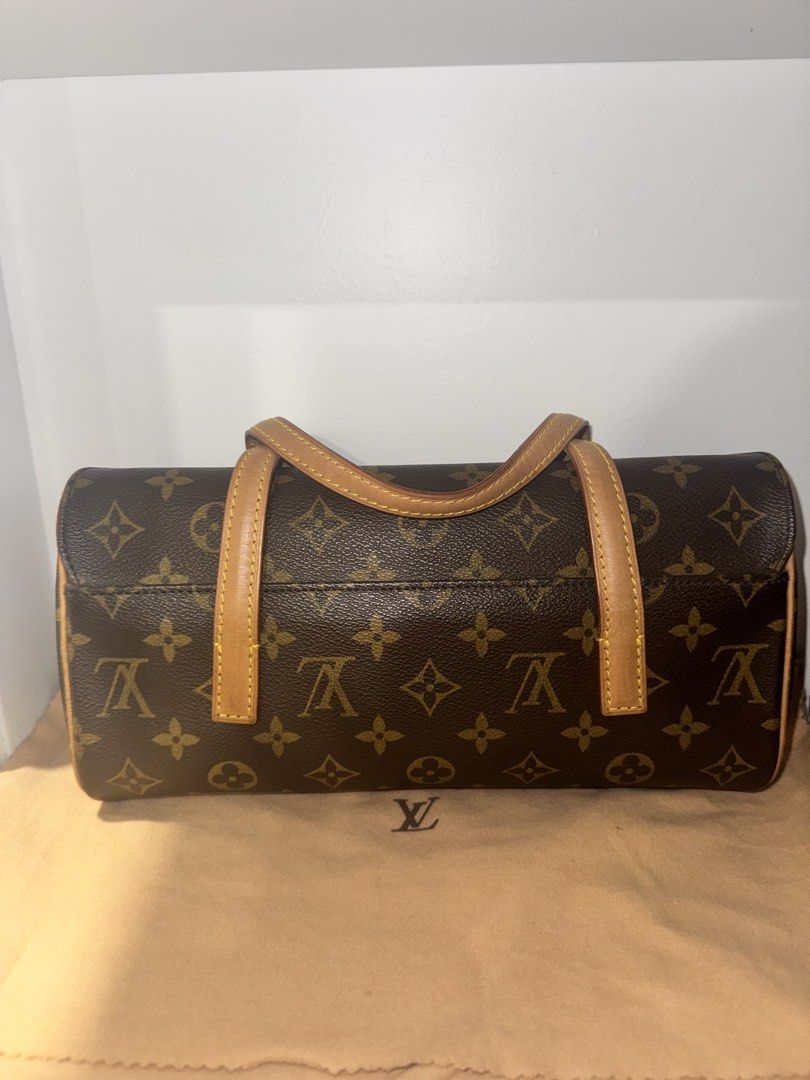 Louis Vuitton Sonatine Handbag (Category: Luxury Bags & Wallets) located in Manila. Submitted by coolwolf_7ee5a0 (Listing ID 1466912758, Image 2). Description: Inclusions: Entrupy and Original Dustbag - Authentic Louis Vuitton monogram canvas handbag - Classic brown LV print with durable tan leather top handles - Elegant structured side profile with a vibrant contrast red interior trim and flap opening - Compact size, making it an ideal daily sho