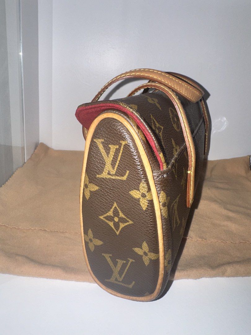 Louis Vuitton Sonatine Handbag (Category: Luxury Bags & Wallets) located in Manila. Submitted by coolwolf_7ee5a0 (Listing ID 1466912758, Image 3). Description: Inclusions: Entrupy and Original Dustbag - Authentic Louis Vuitton monogram canvas handbag - Classic brown LV print with durable tan leather top handles - Elegant structured side profile with a vibrant contrast red interior trim and flap opening - Compact size, making it an ideal daily sho