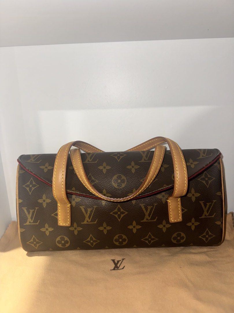 Louis Vuitton Sonatine Handbag (Category: Luxury Bags & Wallets) located in Manila. Submitted by coolwolf_7ee5a0 (Listing ID 1466912758, Image 1). Description: Inclusions: Entrupy and Original Dustbag - Authentic Louis Vuitton monogram canvas handbag - Classic brown LV print with durable tan leather top handles - Elegant structured side profile with a vibrant contrast red interior trim and flap opening - Compact size, making it an ideal daily sho