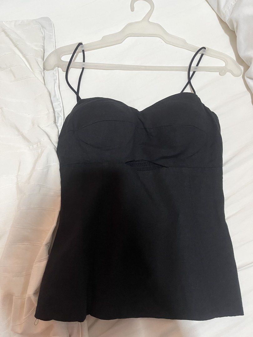 Love Bonito Bustier Black Top (Category: Sleeveless) located in Manila. Submitted by tk555_ (Listing ID 1466783330, Image 2). Description: - Color: Black - Style: Corset-style cami top with a fitted silhouette - Neckline: Sweetheart neckline with thin spaghetti straps - Design Feature: Cutout detail under the bust on the front - Styling Tip: Pairs great with high-waisted skirts or jeans - Condition: Worn only once, practically spotless.