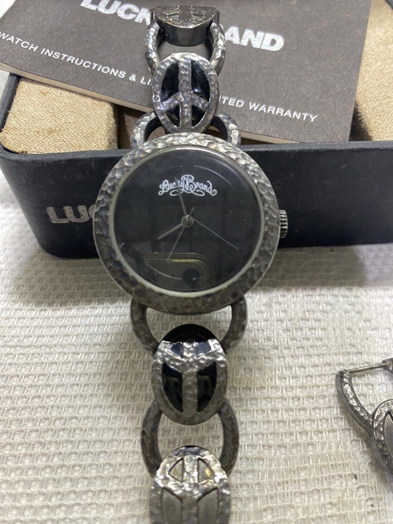 Lucky Brand watch (Category: Women's Watches) located in Angeles City. Submitted by noagrace (Listing ID 1466786315, Image 3). Description: A Lucky Brand women’s silver-tone peace sign watch featuring a black dial and a hammered metal link bracelet. Complete with box Normal signs of use No battery P1000.