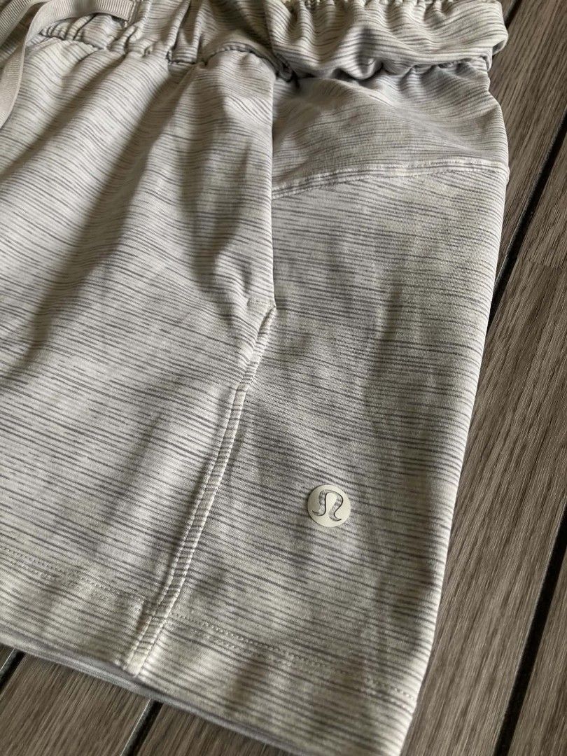 Lululemon Grey Striped Athletic Shorts Size 2 (Category: Shorts) located in Trece Martires City. Submitted by djaothriftshop (Listing ID 1466847870, Image 3). Description: waist 26-30" length 12" hem 11" - Brand: Lululemon - Size: 2 - Color: Grey and white stripes - Features: Elastic waistband, adjustable drawstring with metal aglets, and side pockets - Details: Signature omega logo on lower left leg - Condition: Great lightweight shorts with min