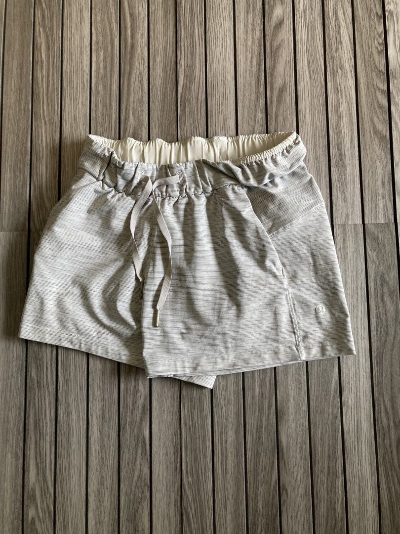 Lululemon Grey Striped Athletic Shorts Size 2 (Category: Shorts) located in Trece Martires City. Submitted by thriftkoto.91 (Listing ID 1466848176, Image 1). Description: - Brand: Lululemon - Size: 2 - Color/Pattern: Grey space dye stripe - Features: Elastic waist with adjustable ribbed drawstring, logo-stamped metal aglets, front pockets, and iconic silver reflective logo on lower left leg - Condition: Great pre-loved condition with minor wear a