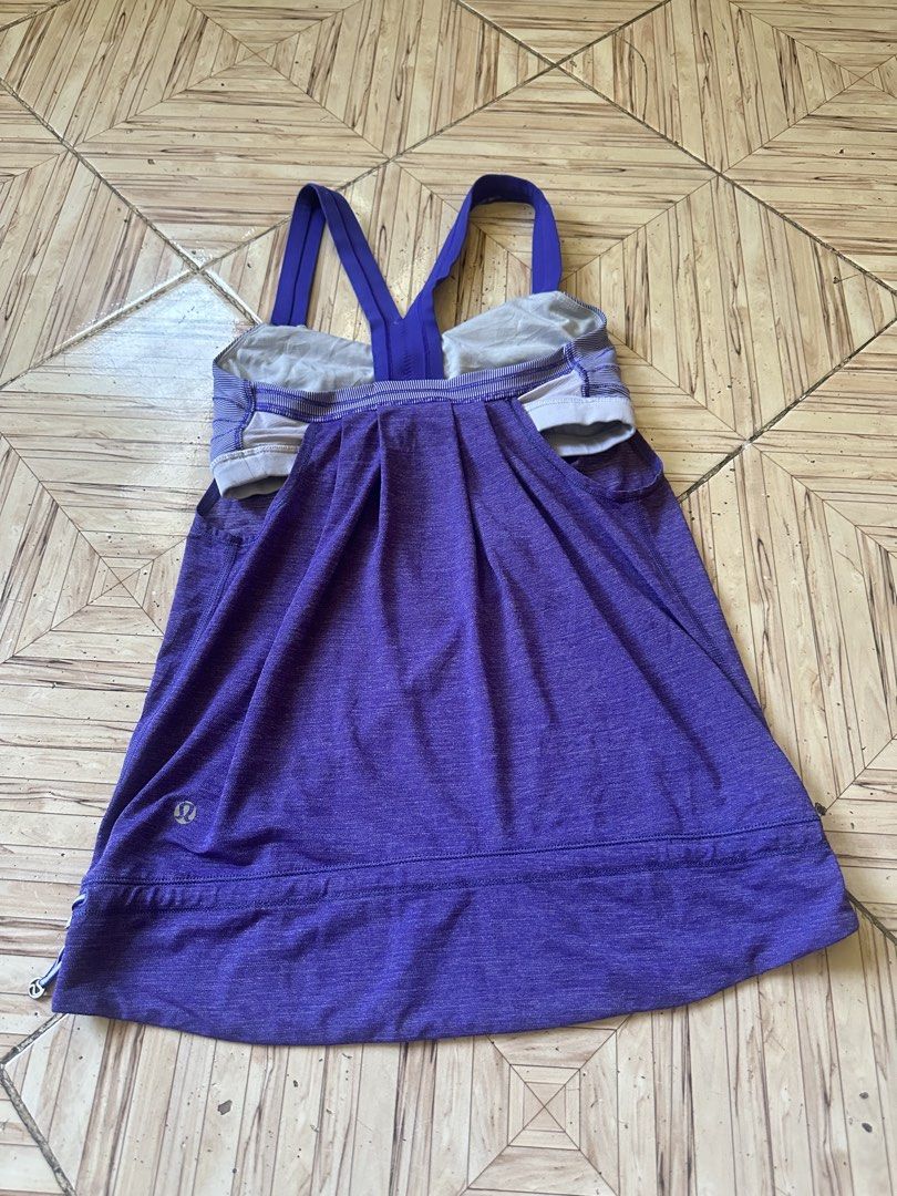 Lululemon Purple Tank Top Size 4 (Category: Sleeveless) located in Angeles City. Submitted by alejeong27 (Listing ID 1466806622, Image 2). Description: - Brand: Lululemon - Color: Purple Melange with solid purple racerback straps - Size: 4 (Dot tag verified inside cup pocket) - Features: Built-in bra with striped lining, adjustable cinched hem with side bungee cords - Ideal for: Gym workouts, yoga, and active wear - Condition: Excellent, well-mai