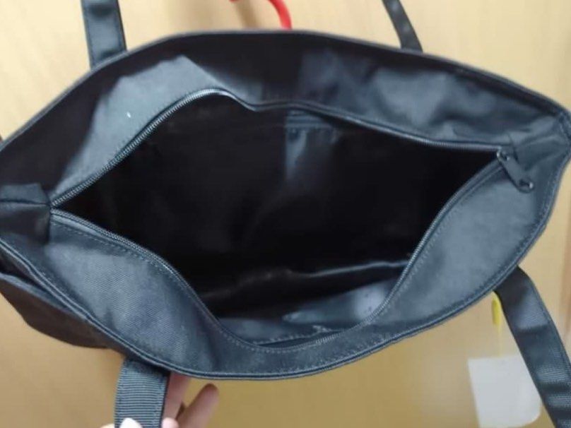 MAH Black Tour Tote Bag (Category: Tote Bags) located in Rizal. Submitted by prelovedthreadsss (Listing ID 1466945773, Image 2). Description: - Brand: MAH - Color: Solid black - Condition: Brand new with original tag and branded yellow packaging - Features: Secure top zipper closure, sturdy fabric handles, multiple inner and outer slip pockets for easy organization - Style: Minimalist and roomy, ideal for daily commuting or school.