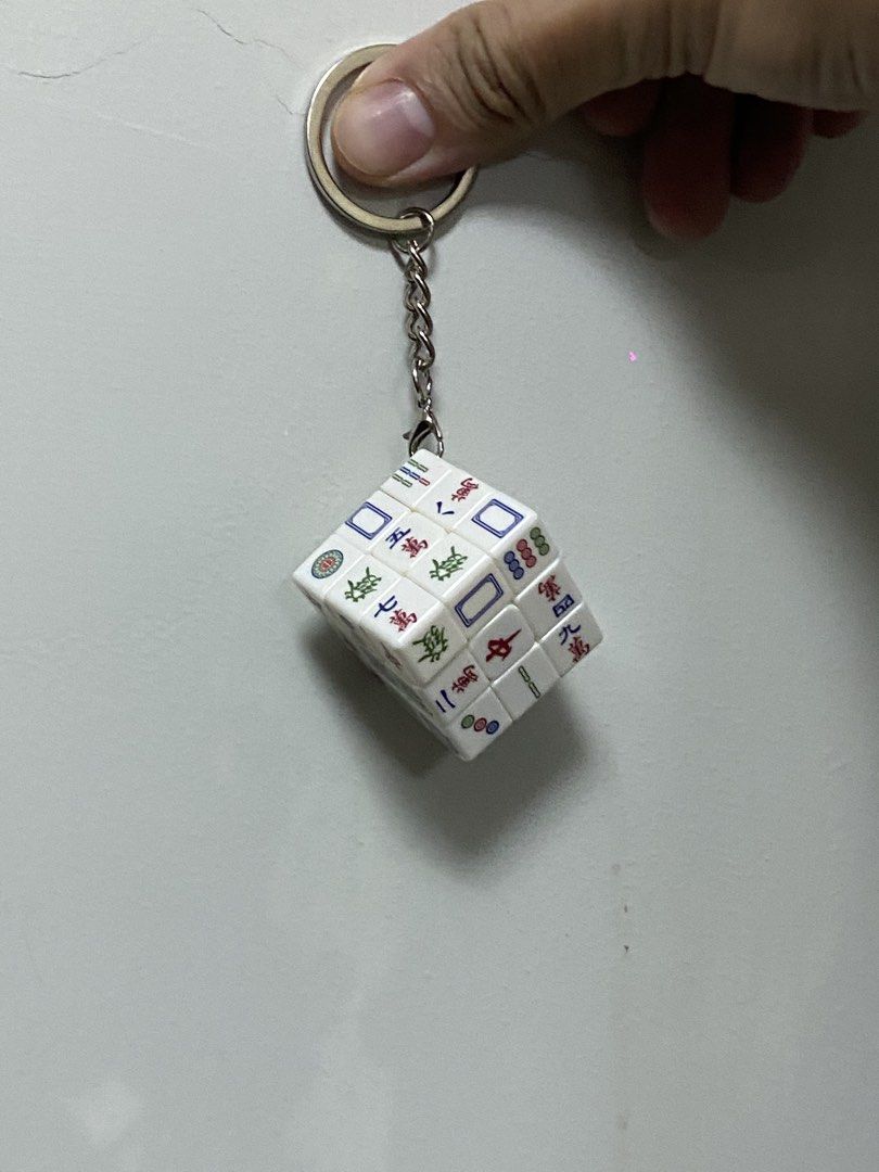 Mahjong Tile Rubik's Cube HongKong Keychain (Category: Board Games & Puzzles) located in Cebu City. Submitted by bred_bt (Listing ID 1466952629, Image 2). Description: - Mini Rubik's cube puzzle shaped like traditional mahjong tiles - Fully functional twist puzzle for on-the-go fidgeting - Sturdy metal keyring with a short chain attached - Perfect cute bag charm and great conversation starter for mahjong lovers - Brand new and ready to ship.