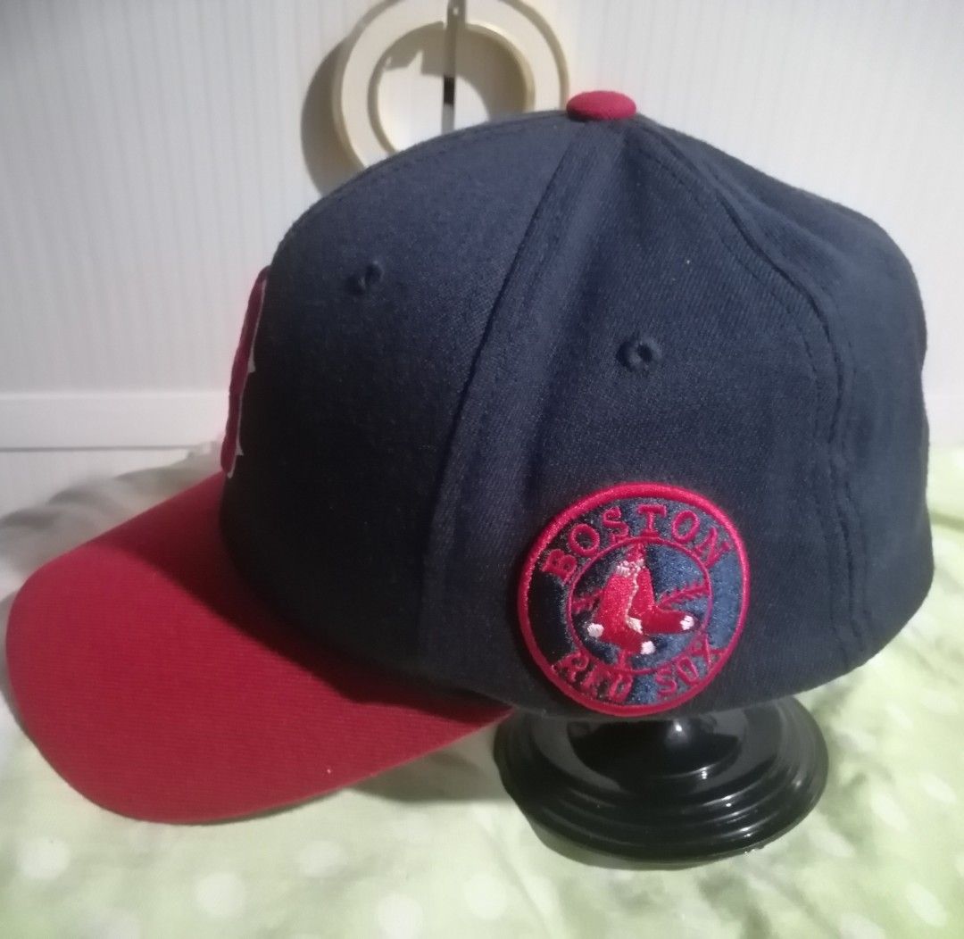Major League Baseball Boston Red Sox Flexfit Hat (Category: Caps & Hats) located in Quezon City. Submitted by rolenalma (Listing ID 1466928234, Image 2). Description: - Authentic Boston Red Sox cap by Major League Baseball - Stylish navy blue crown with contrasting red brim and top button - Embroidered team logo on front, side patch, and MLB logo on back - Unique stitched 'Red Sox' script lettering under the brim - Comfortable Flexfit elastic ban