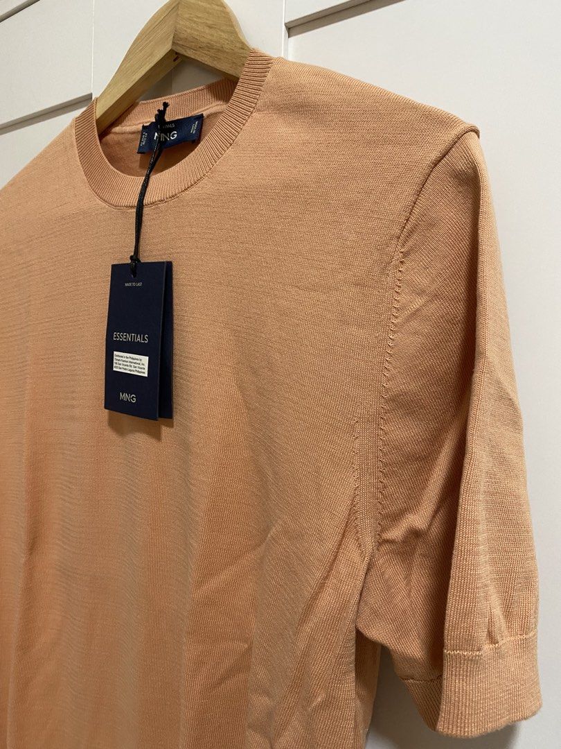 MANGO MAN Essentials Peach Knit Short Sleeve Top Size S (Category: Tshirts & Polo Shirts ) located in Quezon City. Submitted by wearhouze (Listing ID 1466887613, Image 2). Description: MNG Essentials short sleeve knit top in peach orange. Crew neck style with ribbed collar, cuffs, and hem. Size S, fits EU, USA, MEX. Made in China. Original tags still attached..