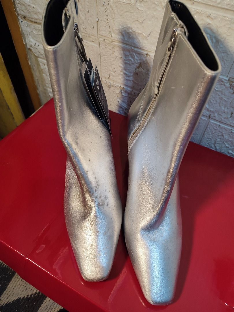 Marks and Spencer Metallic Silver Boots Size UK 6 (Category: Boots) located in Caloocan City. Submitted by jel_gielle (Listing ID 1466934391, Image 1). Description: - Brand: Marks & Spencer - Style: Metallic silver kitten heel ankle boots with square toe and side zippers - Size: UK 5 / EUR 38 - Condition: Brand new with tags attached (Original Price: PHP 4,950) - Material: Non-leather, 100% vegan friendly - Country of Origin: Made in Cambodia.
