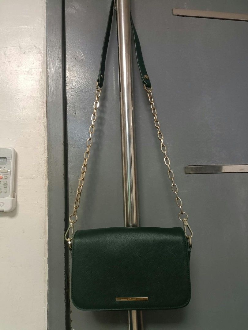 Mclanee sling bag (Category: Cross-body Bags) located in Manila. Submitted by reneemaygo42069 (Listing ID 1466882571, Image 1). Description: - Color: Dark green - Material: Premium Saffiano leather texture - Hardware: Elegant gold-tone chain and leather strap - Closure: Foldover flap with a sleek front metallic bar label - Interior: Clean and spacious - Best for: Everyday use, casual outings, or work 👜✨ Preloved Bags for Sale! ✨ Decluttering my 