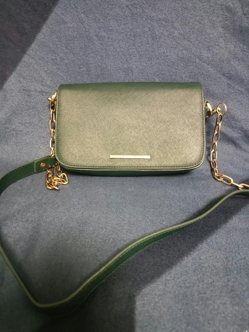 Mclanee sling bag (Category: Cross-body Bags) located in Manila. Submitted by reneemaygo42069 (Listing ID 1466882571, Image 2). Description: - Color: Dark green - Material: Premium Saffiano leather texture - Hardware: Elegant gold-tone chain and leather strap - Closure: Foldover flap with a sleek front metallic bar label - Interior: Clean and spacious - Best for: Everyday use, casual outings, or work 👜✨ Preloved Bags for Sale! ✨ Decluttering my 