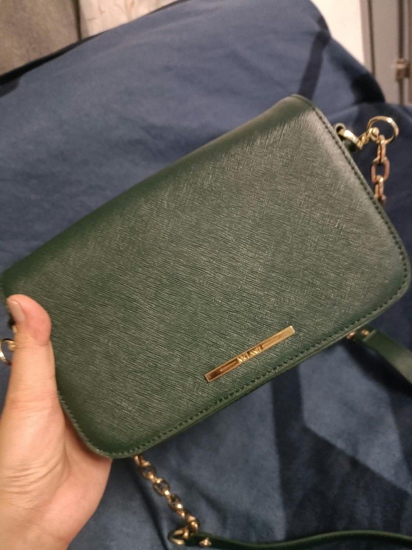 Mclanee sling bag (Category: Cross-body Bags) located in Manila. Submitted by reneemaygo42069 (Listing ID 1466882571, Image 3). Description: - Color: Dark green - Material: Premium Saffiano leather texture - Hardware: Elegant gold-tone chain and leather strap - Closure: Foldover flap with a sleek front metallic bar label - Interior: Clean and spacious - Best for: Everyday use, casual outings, or work 👜✨ Preloved Bags for Sale! ✨ Decluttering my 
