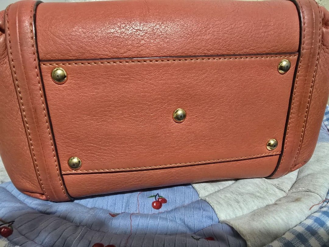 MCM Orange Leather Tote Shoulder Bag (Category: Cross-body Bags) located in Manila. Submitted by coolbear.5772e6 (Listing ID 1466859123, Image 2). Description: - Brand: MCM - Material: Premium pebble leather in bright coral orange - Hardware: Gold-tone with front logo plaque and serial number Y4784 - Straps: Dual top handles + adjustable, detachable shoulder strap - Base: Structured bottom with 5 protective metal feet - Condition/Interior: Clean 