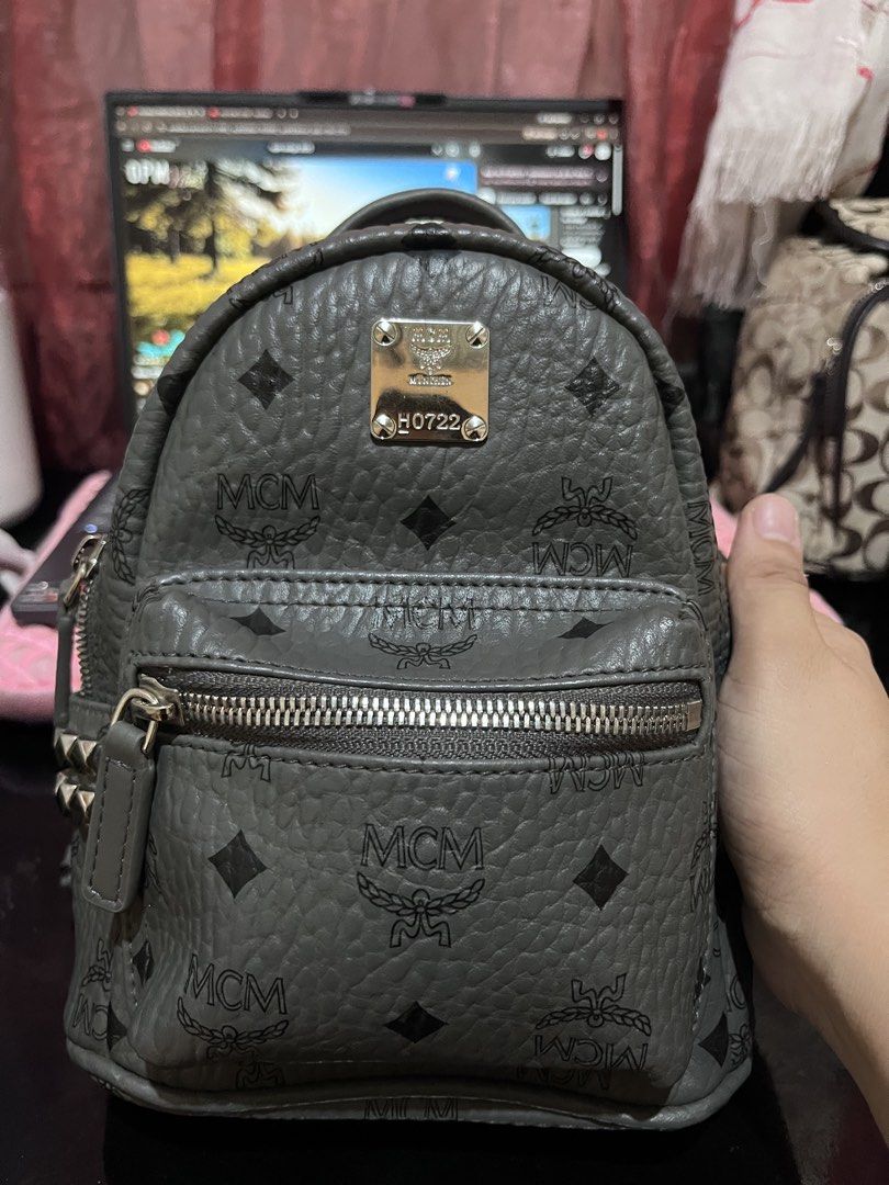 📍Flash Saleee MCM Stark Mini Backpack Grey Studded Monogram (Category: Backpacks) located in Manila. Submitted by madecuratedwithlove11 (Listing ID 1466858200, Image 1). Description: - grey MCM mini backpack with iconic all-over monogram print - Ykk zip -Turnable logo - Edgy studded details on the side pockets for a stylish look - Secure silver-tone hardware and smooth zipper closure - Convenient front zip pocket for quick access to essentials -