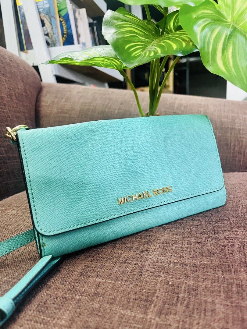Michael Kors (Category: Cross-body Bags) located in Quezon City. Submitted by retann (Listing ID 1466968795, Image 1). Description: - Brand: Michael Kors - Color: Mint green - Material: Premium leather - Hardware: Gold-toned - Design: Structured rectangular shape with front flap and matching thin strap - Style: Minimalist and versatile - Condition: Mint / Excellent - Perfect for: Everyday use and casual outings.