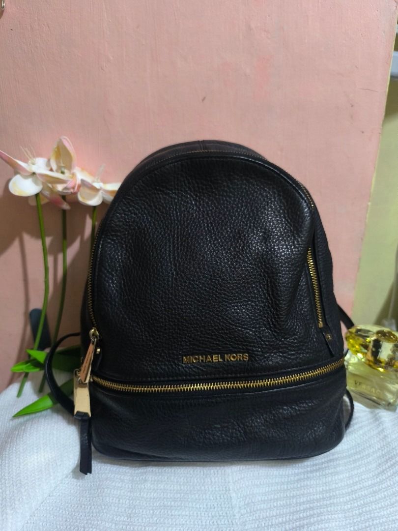 Michael Kors Black Leather Backpack (Category: Backpacks) located in Cebu City. Submitted by re-amoreph_2014 (Listing ID 1466962396, Image 1). Description: - Brand: Michael Kors - Material: Genuine black pebbled leather with natural texture - Hardware: Premium gold-toned hardware with double zipper pulls - Storage: Spacious main zip compartment and convenient front zip pocket - Interior: Dark fabric lining with Made in Vietnam tag - Straps: Comfo