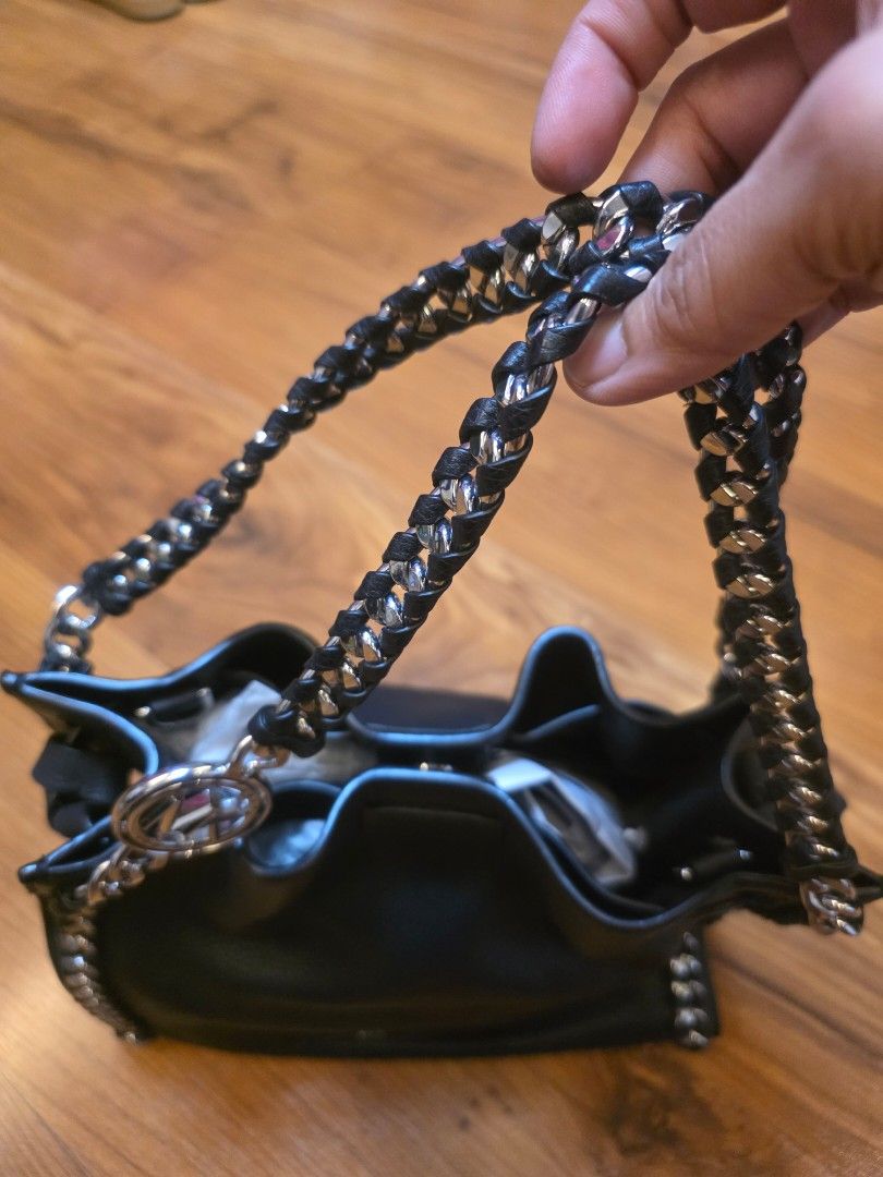 Michael Kors Black Leather Chain Shoulder Bag (Category: Luxury Bags & Wallets) located in Iligan City. Submitted by ilovechocolatecakes (Listing ID 1466778487, Image 2). Description: - Brand: Michael Kors - Material: Black pebbled leather - Hardware: Silver-tone chain strap interwoven with leather - Closure: Magnetic snap top closure - Interior: Clean lining with stamped branding text on internal leather trim - Base: Flat structured base - Condi