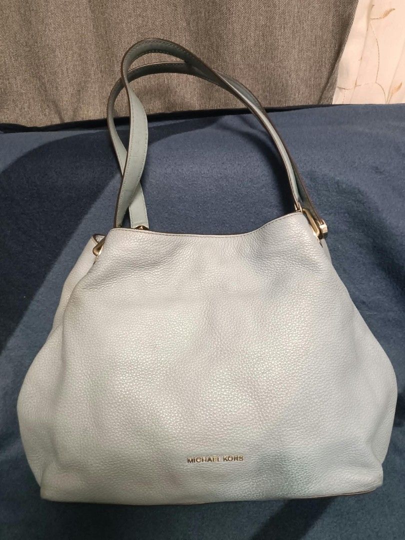 Michael Kors Blue Leather Shoulder Bag (Category: Shoulder Bags) located in Manila. Submitted by reneemaygo42069 (Listing ID 1466881587, Image 2). Description: - Brand: Michael Kors - Material: Soft light blue pebbled leather - Design: Slouchy shape with dual shoulder straps - Hardware: Gold-tone accents and subtle gold logo stamp - Storage: Spacious main interior compartment - Condition: Excellent, well-maintained 👜✨ Preloved Bags for Sale! ✨ D