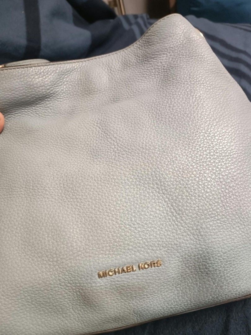 Michael Kors Blue Leather Shoulder Bag (Category: Shoulder Bags) located in Manila. Submitted by reneemaygo42069 (Listing ID 1466881587, Image 3). Description: - Brand: Michael Kors - Material: Soft light blue pebbled leather - Design: Slouchy shape with dual shoulder straps - Hardware: Gold-tone accents and subtle gold logo stamp - Storage: Spacious main interior compartment - Condition: Excellent, well-maintained 👜✨ Preloved Bags for Sale! ✨ D
