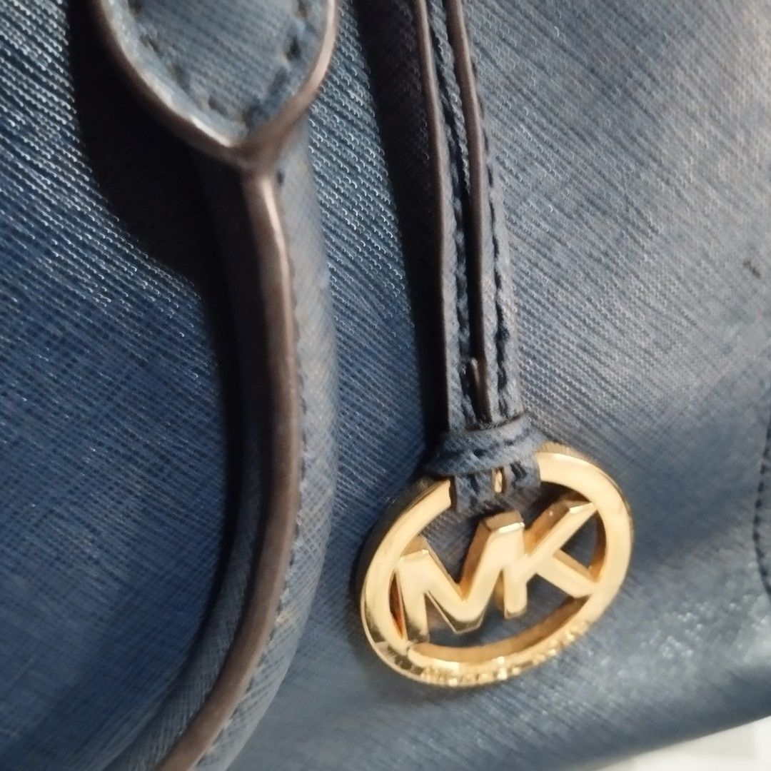 Michael Kors Blue Tote Bag (Category: Tote Bags) located in Manila. Submitted by lene48 (Listing ID 1466845517, Image 2). Description: - Authentic Michael Kors blue leather tote bag - Elegant gold-tone hardware with signature hanging MK charm - Secure double zip compartments and open main section with magnetic snap closure - Logo-print interior lining equipped with convenient slip pockets and key leash - Protective feet on the bottom base for dur